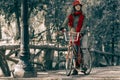Young woman riding red vintage bike on fall season Royalty Free Stock Photo