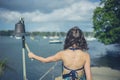 Woman ringing bell to call boatman