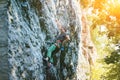 Young woman rock climber climbing on the cliff Royalty Free Stock Photo