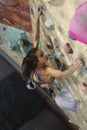 Young Woman Rock climber is Climbing At Inside climbing Gym. slim pretty Woman Exercising At Indoor Climbing Gym Wall Royalty Free Stock Photo