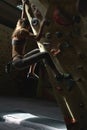 Young Woman Rock climber is Climbing At Inside climbing Gym. slim pretty Woman Exercising At Indoor Climbing Gym Wall Royalty Free Stock Photo
