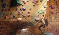 Young Woman Rock climber is Climbing At Inside climbing Gym. slim pretty Woman Exercising At Indoor Climbing Gym Wall Royalty Free Stock Photo