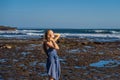 A young woman on a rocky cosmic Bali shore