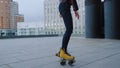 Sporty girl riding on roller skates outside. Woman circling on rollerblades. Royalty Free Stock Photo