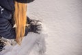 Young woman rolling giant snowball to make snowman Royalty Free Stock Photo