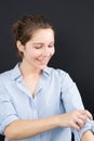 Young woman rolling up her shirt sleeves