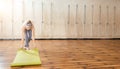 Young woman rolling yoga mat in yoga studio before training class. Copy space Royalty Free Stock Photo