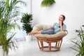 Young woman in room decorated with plants Royalty Free Stock Photo