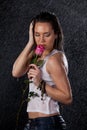 Young woman with rose under rain. Royalty Free Stock Photo