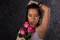 Young woman with roses under rain. Royalty Free Stock Photo