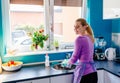 Young woman in rubber gloves washing dishes Royalty Free Stock Photo