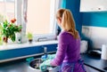 Young woman in rubber gloves washing dishes Royalty Free Stock Photo