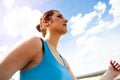 Young woman runing in the city over the brige in sun light.