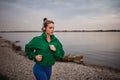 Young woman runing outdoor, near the lake.