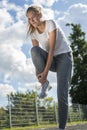 Young woman runner hold her sports injured leg Royalty Free Stock Photo