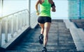 Woman running up city stairs