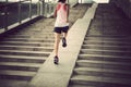 Woman running up city stairs