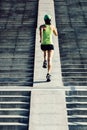 Woman running up city stairs