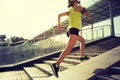 Woman running up city stairs jogging and running