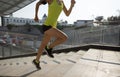 Woman running up city stairs jogging