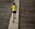 Woman running up city stairs