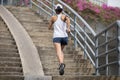 sportswoman running up city stairs