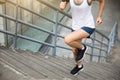 Woman runner sportswoman running up city stairs