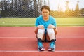 Woman runner suffering from pain in legs be injured,Hand touching her knee after jogging on track running Royalty Free Stock Photo