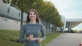 Young woman runner training in summer park city. Portrait of young and fit woman running and jogging alone on the empty Royalty Free Stock Photo