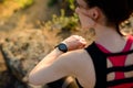 Young Woman Runner Using Multisport Smartwatch at Sunset Trail. Closeup of Hand with Fitness Tracker. Sports Concept Royalty Free Stock Photo