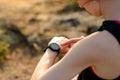 Young Woman Runner Using Multisport Smartwatch at Sunset Trail. Closeup of Hand with Fitness Tracker. Sports Concept. Royalty Free Stock Photo
