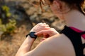 Young Woman Runner Using Multisport Smartwatch at Sunset Trail. Closeup of Hand with Fitness Tracker. Sports Concept Royalty Free Stock Photo