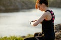 Young Woman Runner Using Multisport Smartwatch at Sunset Trail. Closeup of Hand with Fitness Tracker. Sports Concept Royalty Free Stock Photo