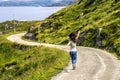 Young woman running along the countryside road