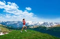 Young woman running along mountains in Colorado. Royalty Free Stock Photo