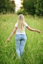 Young woman running along a path in a field at sunset Royalty Free Stock Photo