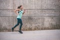 Young woman running away in an industrial scene, during sunrese. Royalty Free Stock Photo