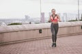 Young woman running away in an industrial scene, during sunrese. Royalty Free Stock Photo