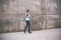 Young woman running away in an industrial scene, during sunrese. Royalty Free Stock Photo