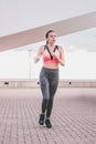 Young woman running away in an industrial scene, during sunrese. Royalty Free Stock Photo