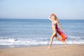 Young woman running on beach Royalty Free Stock Photo