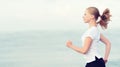 Young woman running on the beach on the coast of the Sea Royalty Free Stock Photo