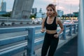 Young woman running at bridge