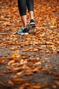 Young woman running in the early evening autumn leaves Royalty Free Stock Photo