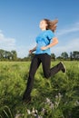 Young woman running on the grass Royalty Free Stock Photo