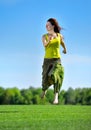 Young woman running on a green meadow Royalty Free Stock Photo