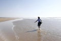 Young woman running happily on a beach