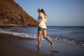 Young woman running on La Tejita beach, Tenerife , Spain Royalty Free Stock Photo