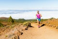 Young woman running in mountains on sunny summer day Royalty Free Stock Photo