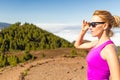 Young woman running in mountains on sunny summer day Royalty Free Stock Photo